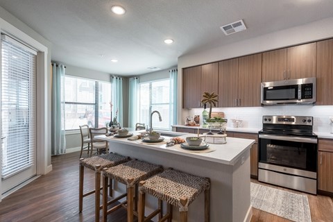 A kitchen with a white countertop and stainless steel appliances.