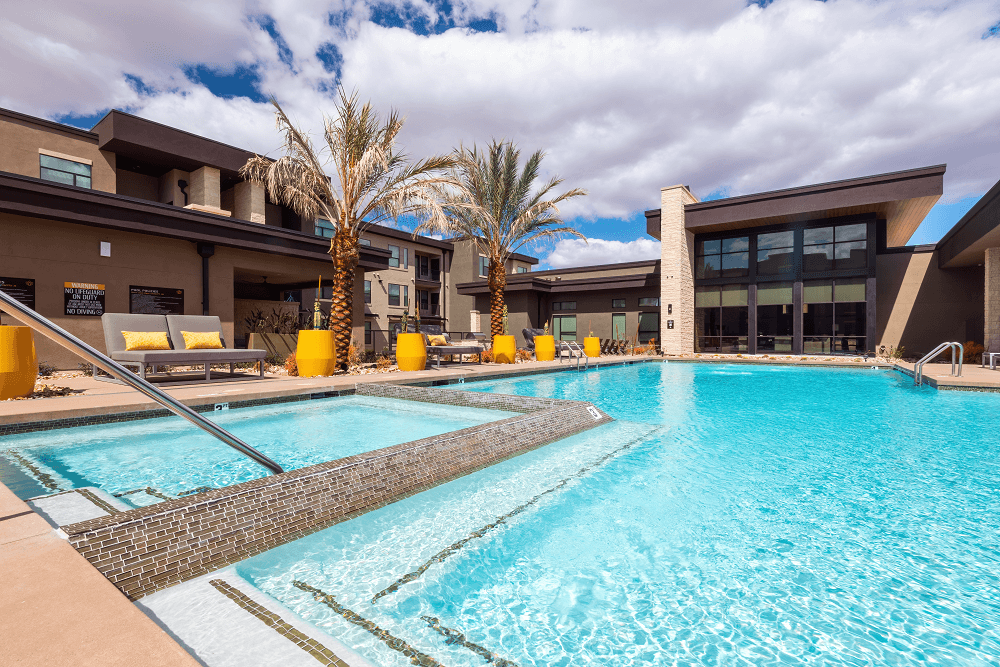 pool area with trees in the background at escape at arrowhead's apartments in glendale, az