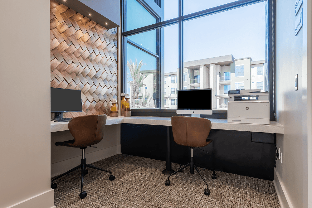 community lounge with computers at escape at arrowhead apartments