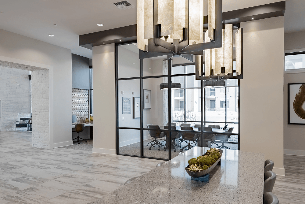 a dining room with glass doors and a table with a bowl of fruit