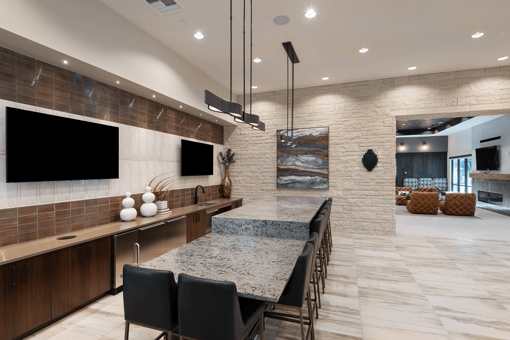 a kitchen and dining room with a long table and chairs