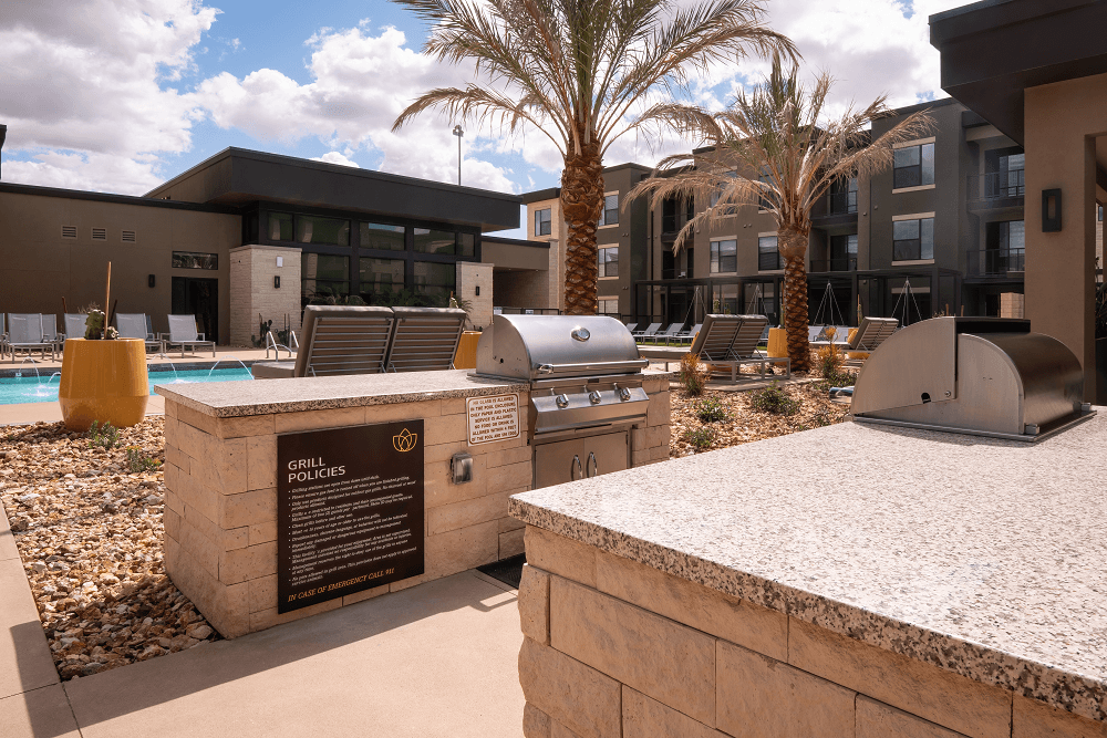 pool area with a grill at escape at arrowhead's apartments in glendale, az
