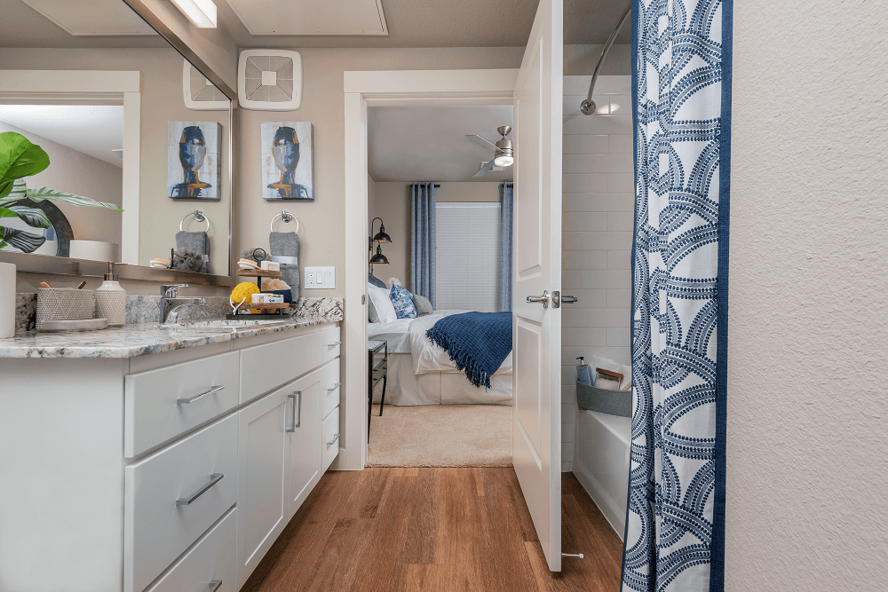 bathroom that's connected to a bedroom at escape at arrowhead's apartments in glendale, az