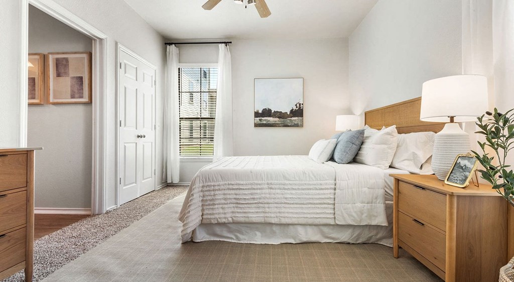 a bedroom with a bed and a ceiling fan