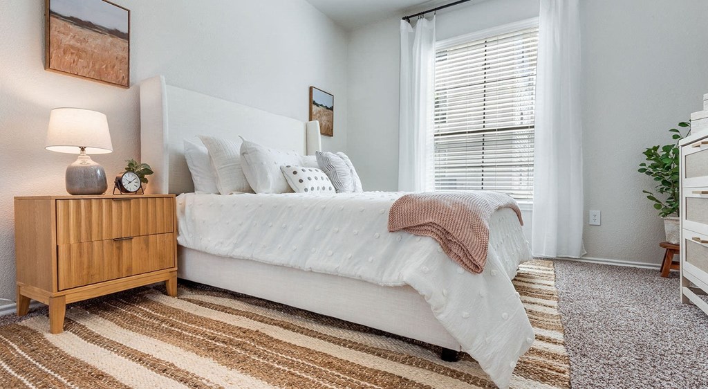 a bedroom with a bed and a dresser