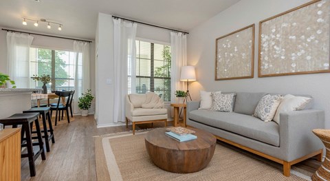 a living room with a couch chair and coffee table