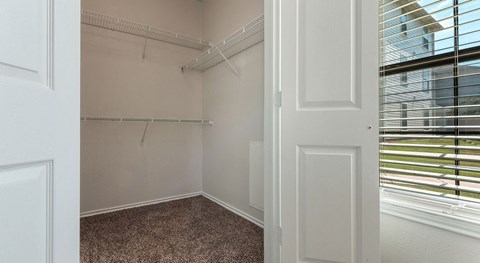 a bedroom with a large window and a white door