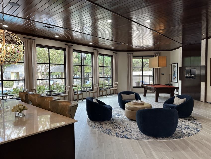 a large living room with a pool table and a bar
