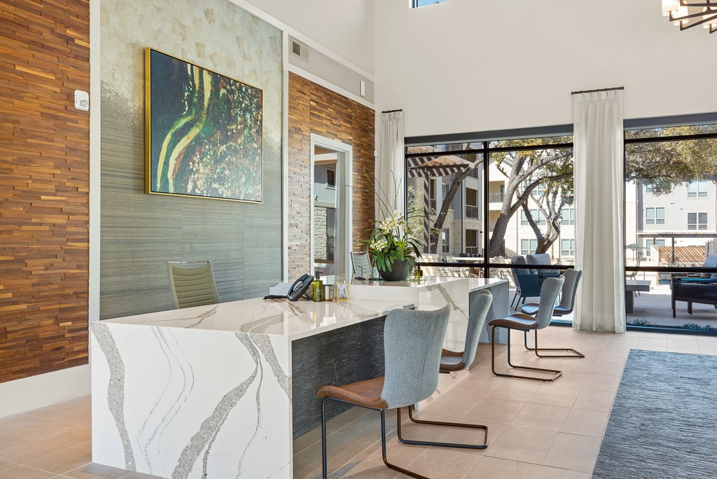 a kitchen with a long counter and a table with chairs