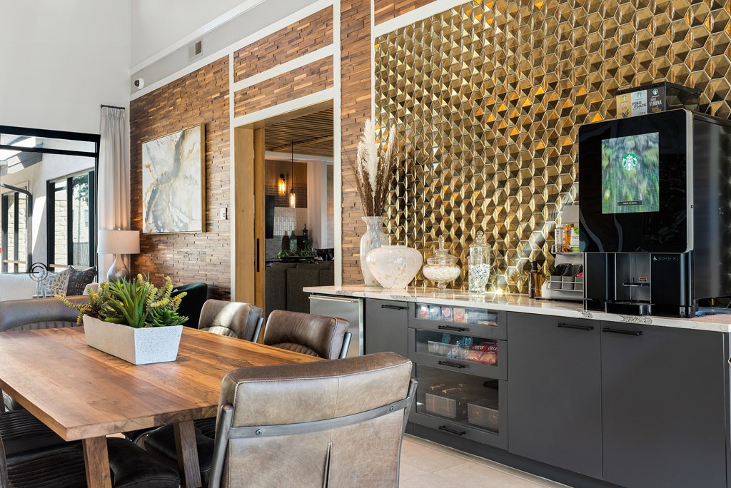 a dining room with a table and chairs and a kitchen with a television