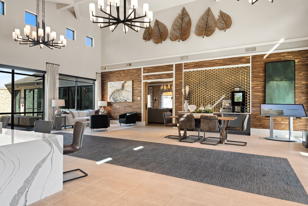 a living room and dining room with a table and chairs