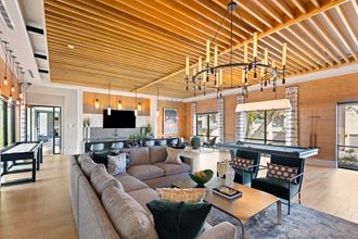 a living room with a couch and a pool table