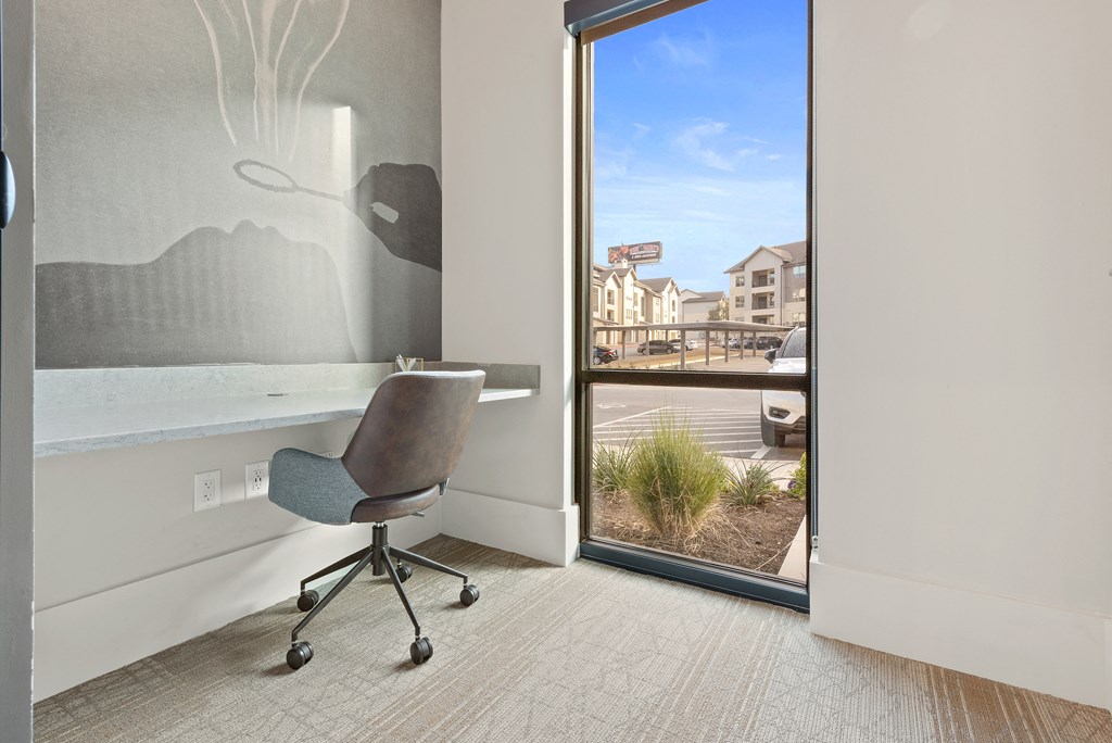 a chair and a desk in a room with a window
