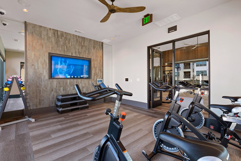 workout room with amenities at ironridge at hill country village apartments