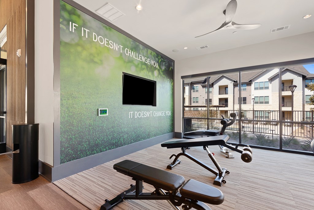 exercise room with amenities at ironridge at hill country village apartments