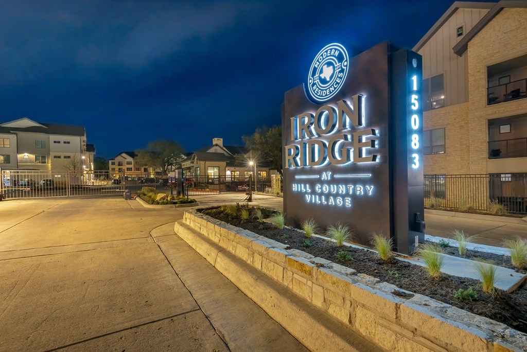 the sign for iron ridge at night in front of an apartment building