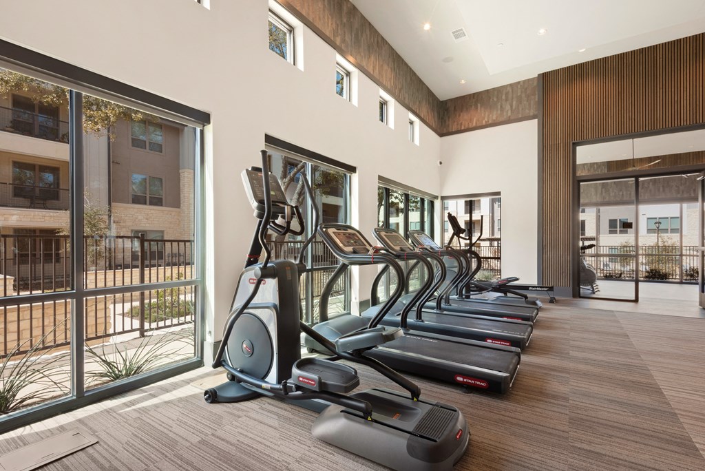 gym with amenities at ironridge at hill country village apartments