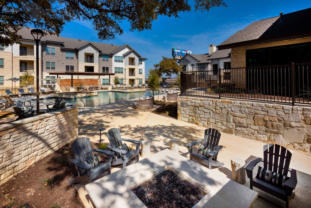 the preserve at ballantyne commons pool and patio with chairs and buildings