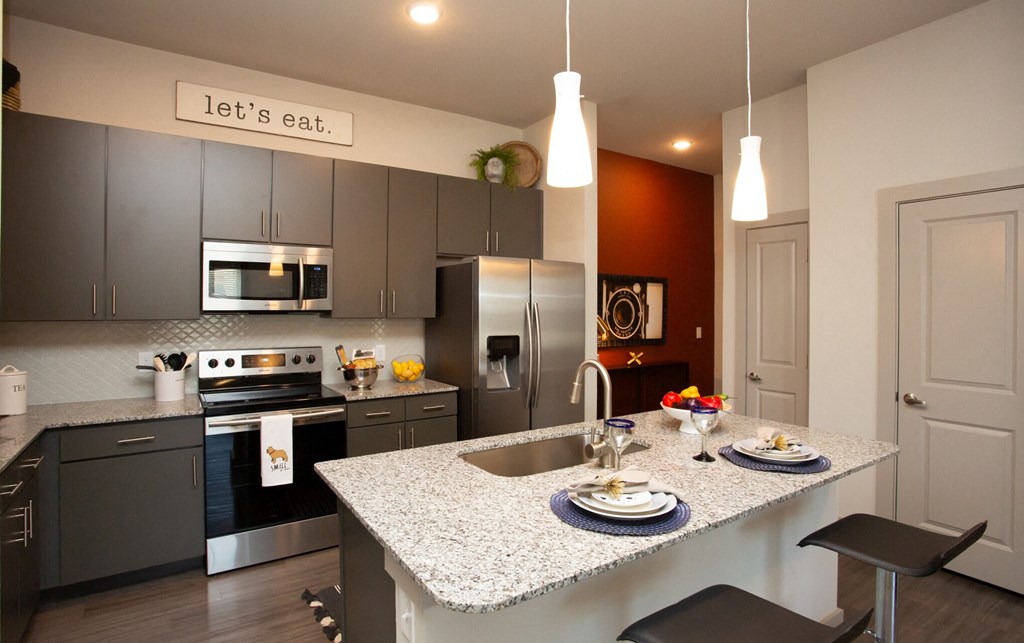 kitchen at mela's apartments in san antonio