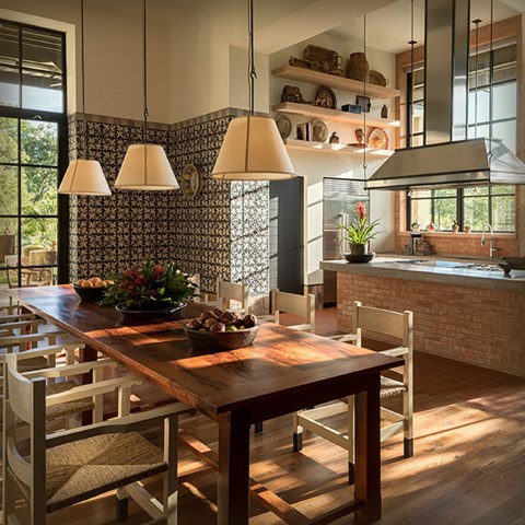 a dining room with a wooden table and chairs and a kitchen
