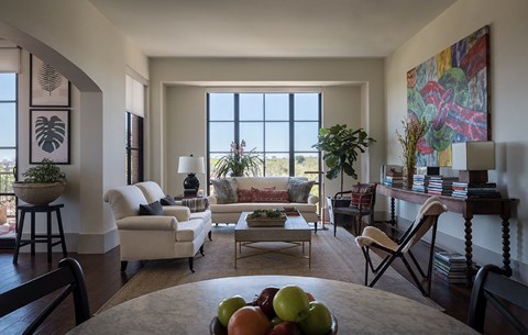 A living room with a table in the middle and a couch in the background.
