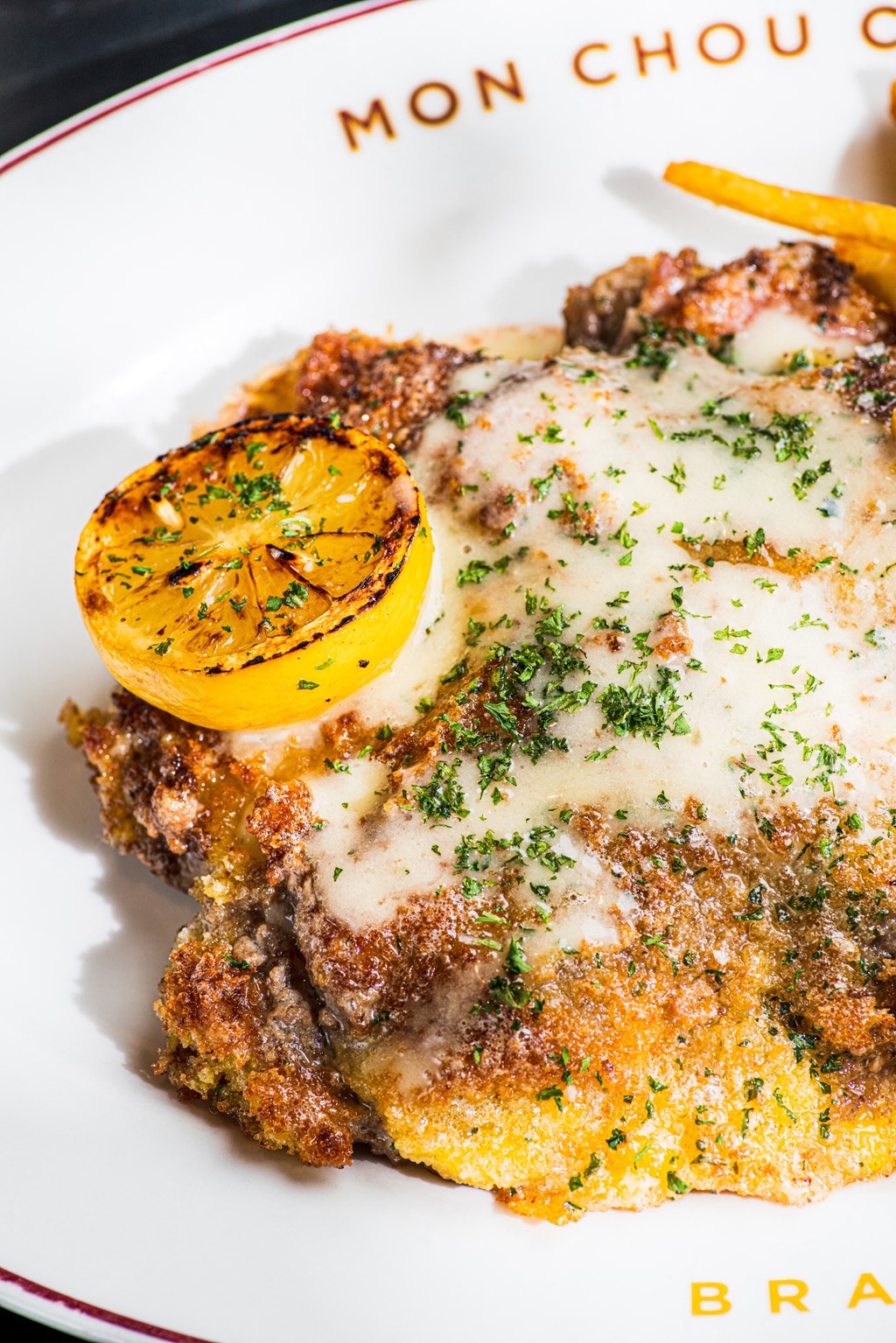 A plate of food with a slice of lemon on top.