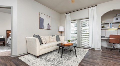 a living room with a white couch and a black coffee table
