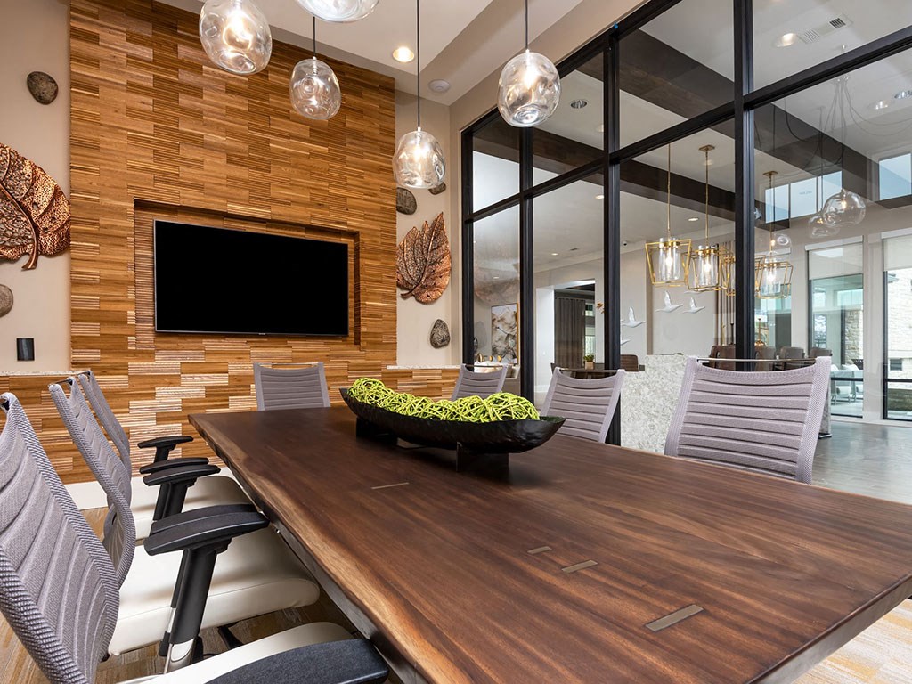 a dining room with a wooden table with a bowl of fruit on it