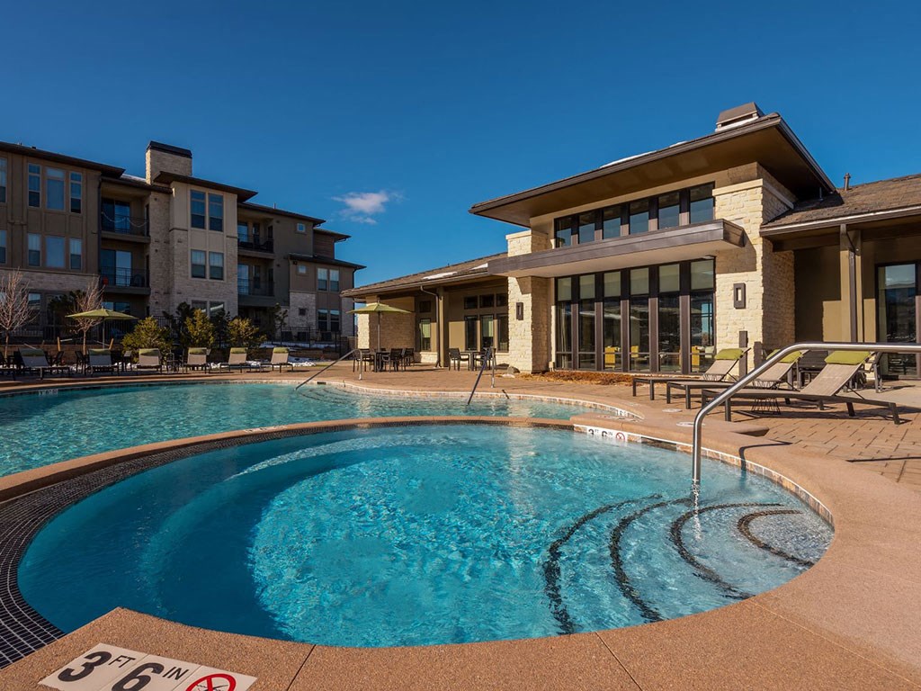 a swimming pool with a building in the background