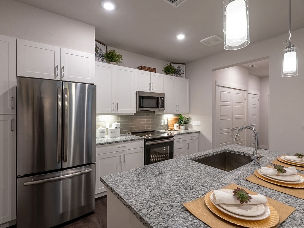 a kitchen with stainless steel appliances and granite counter tops