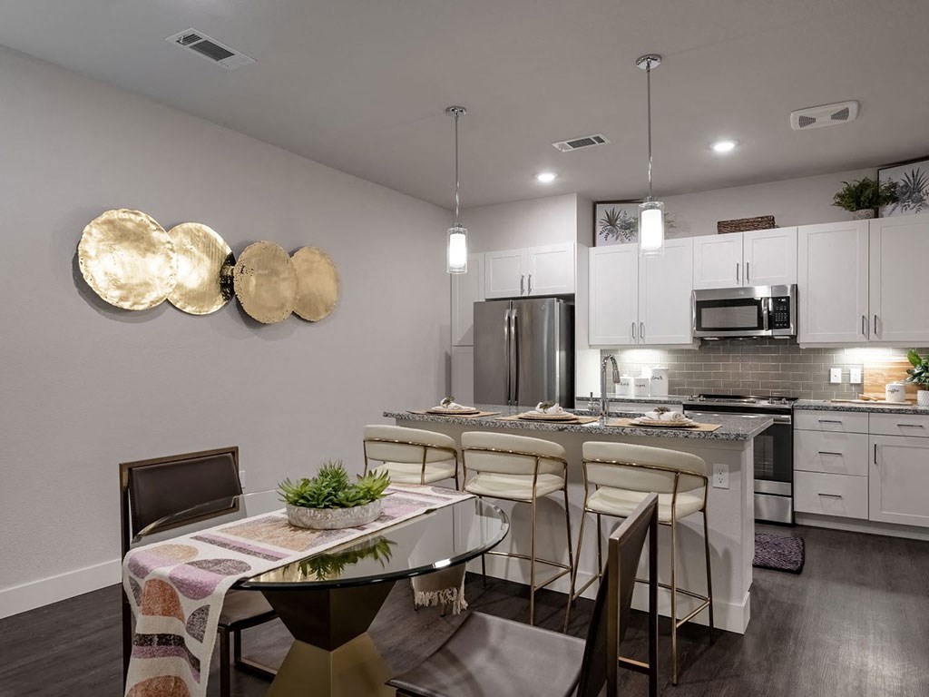 an open kitchen and dining room with a table and chairs