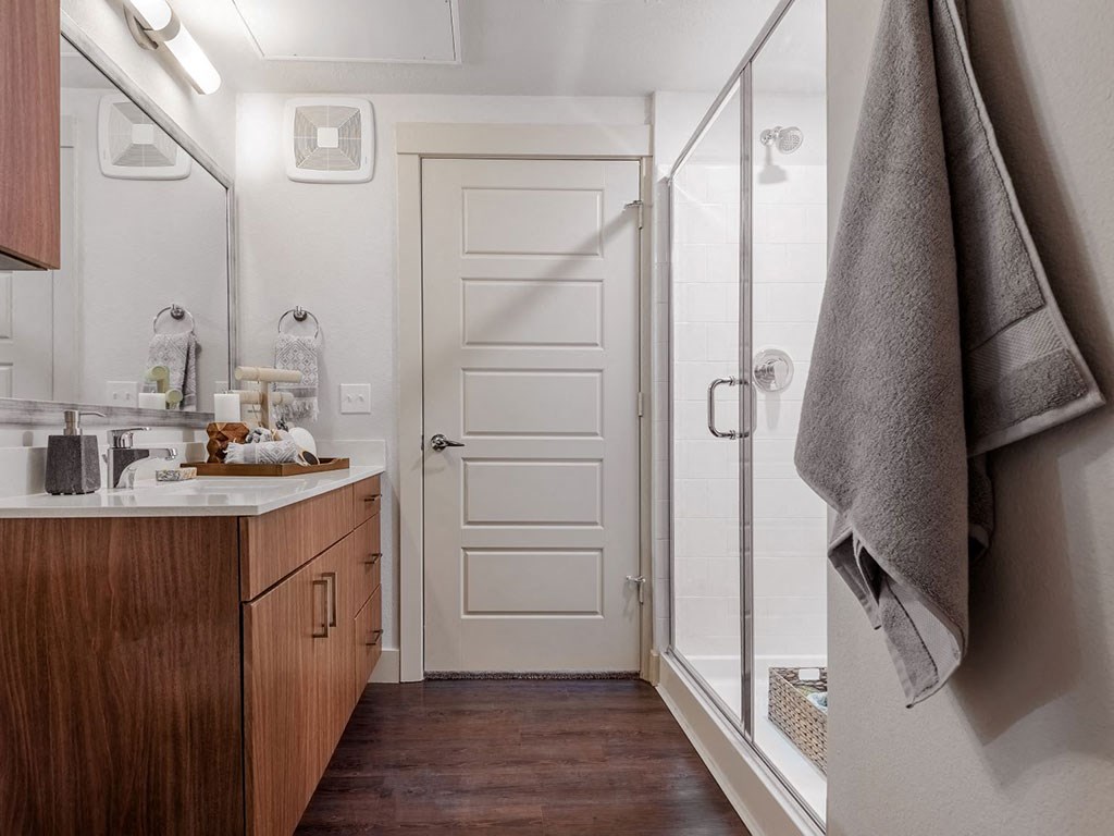 a small bathroom with a shower and a sink and a towel