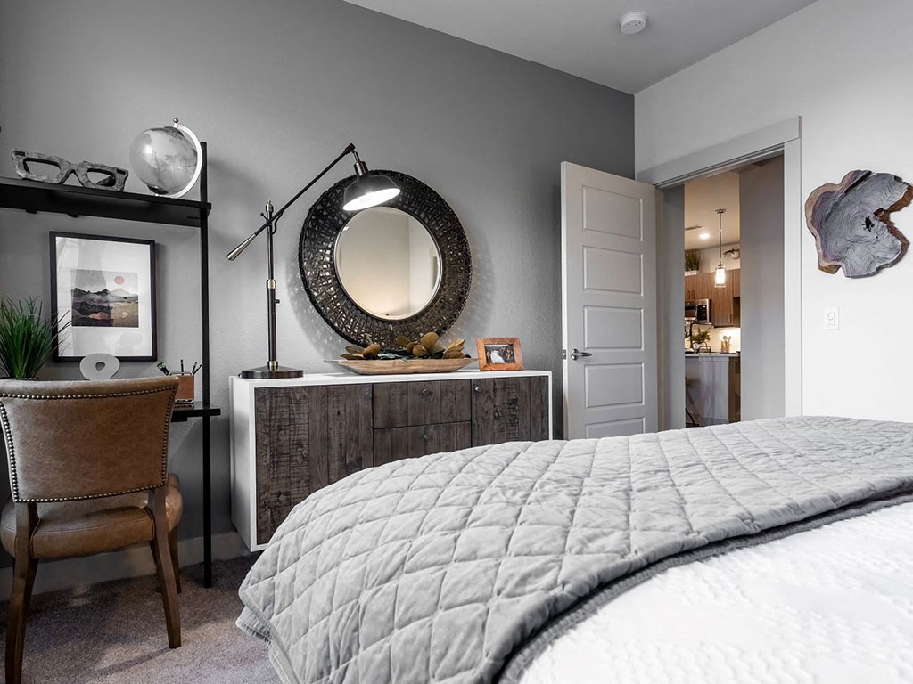 a bedroom with a bed and a mirror