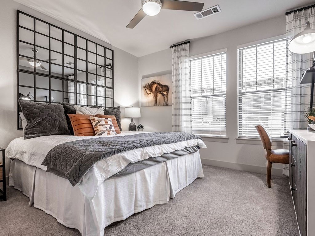 a bedroom with a bed and a mirror