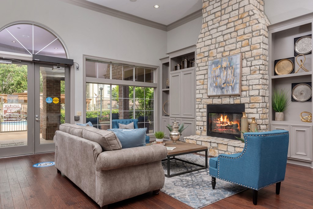 a living room with a stone fireplace and a couch