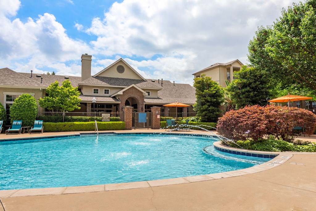 a swimming pool with a house in the background