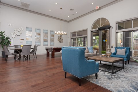 a living room with blue furniture and a dining room table