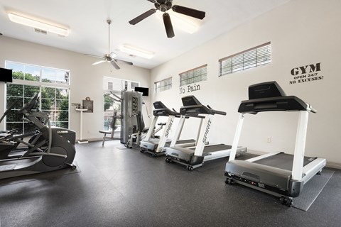 the gym with treadmills and ellipticals at the enclave at woodbridge apartments