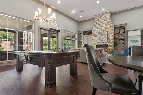 a billiards table in a living room with a fireplace