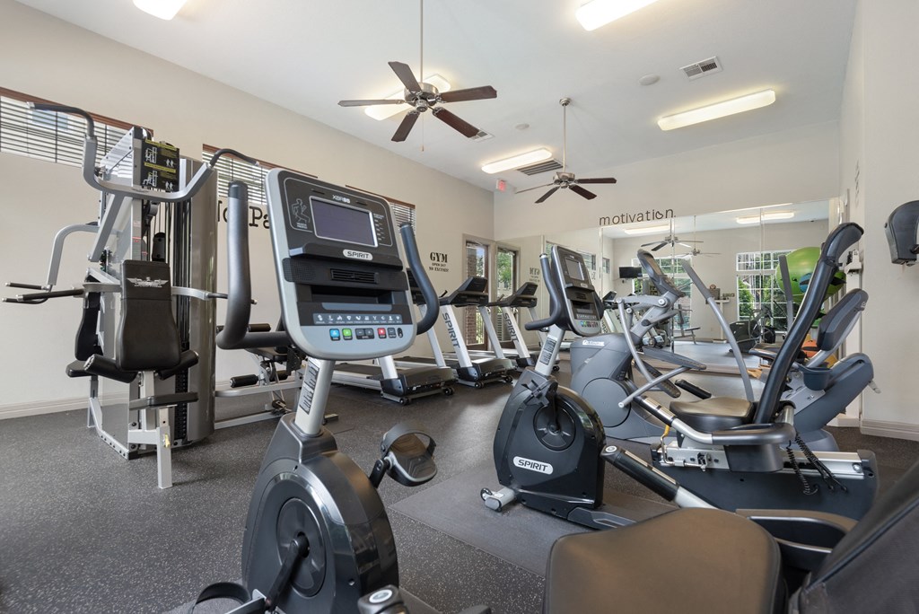 a gym with cardio machines and other exercise equipment at the enclave at woodbury