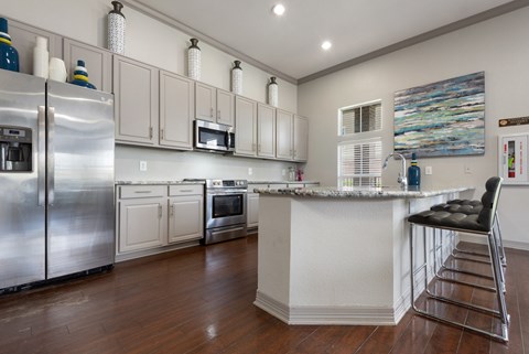 a kitchen with stainless steel appliances and a counter top
