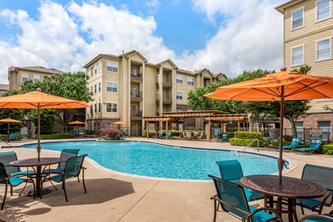 our apartments offer a swimming pool with tables and umbrellas