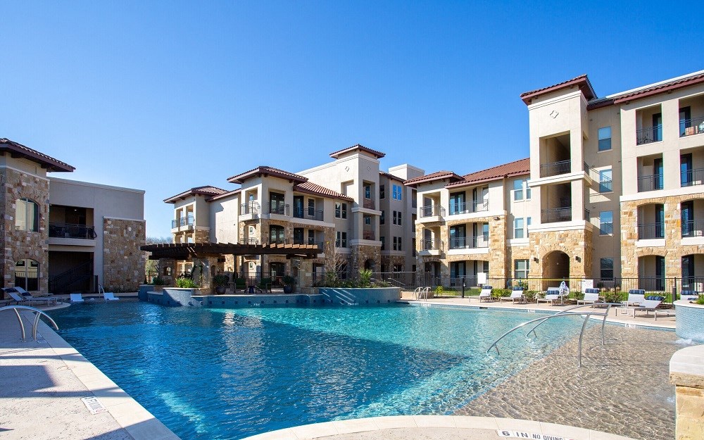 resort-style swimming pool at mela's luxury apartments in san antonio
