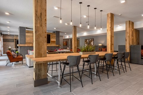 a large communal table with chairs in a kitchen and dining room