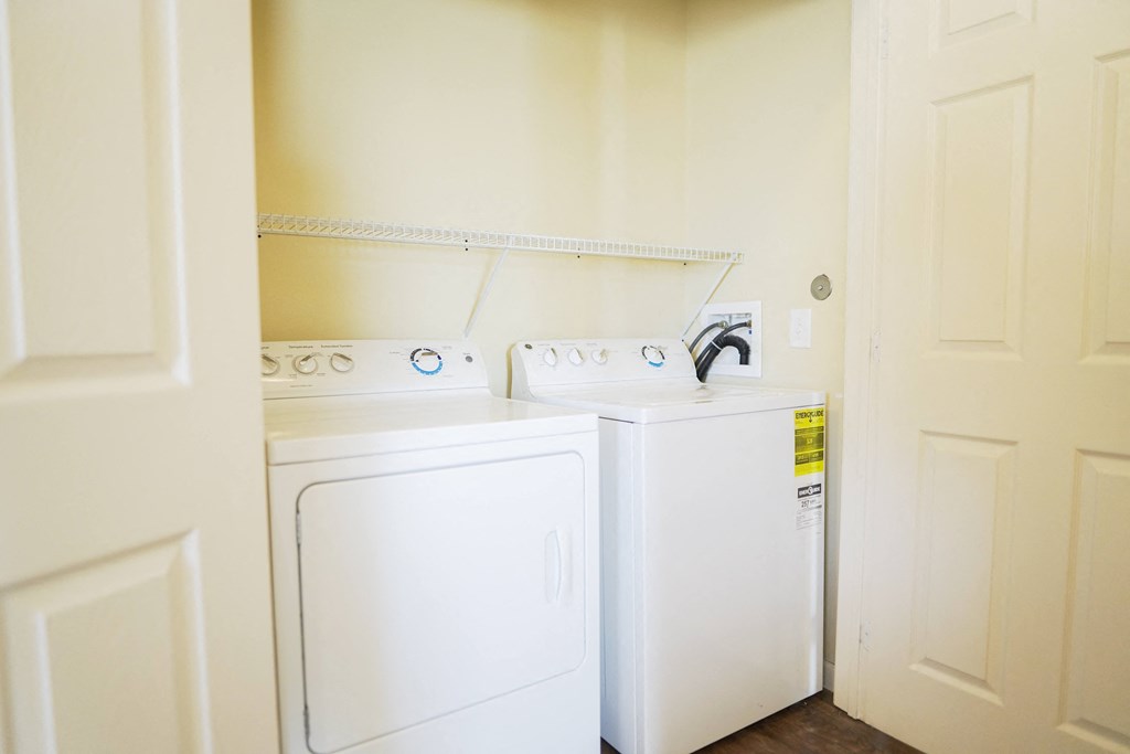 a washer and dryer in a laundry room with a sink