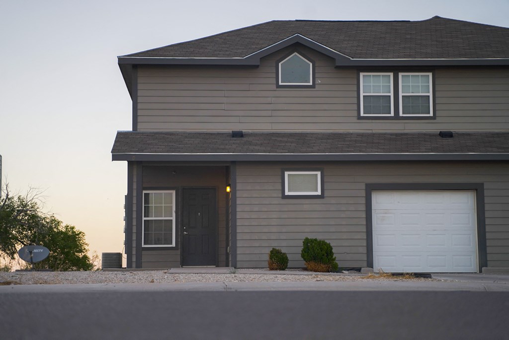 the front of a house with a garage door
