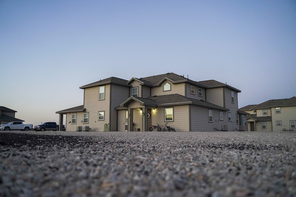 a large house with a gravel driveway in front of it