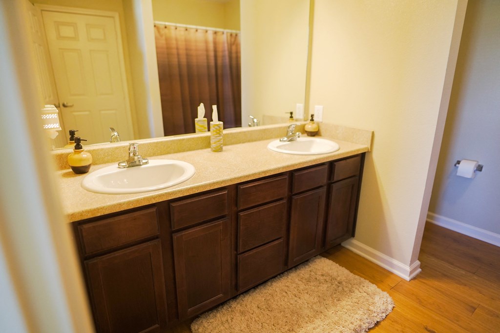 a bathroom with two sinks and a large mirror