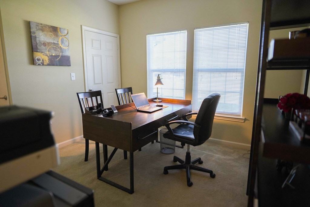 a home office with a desk and a laptop