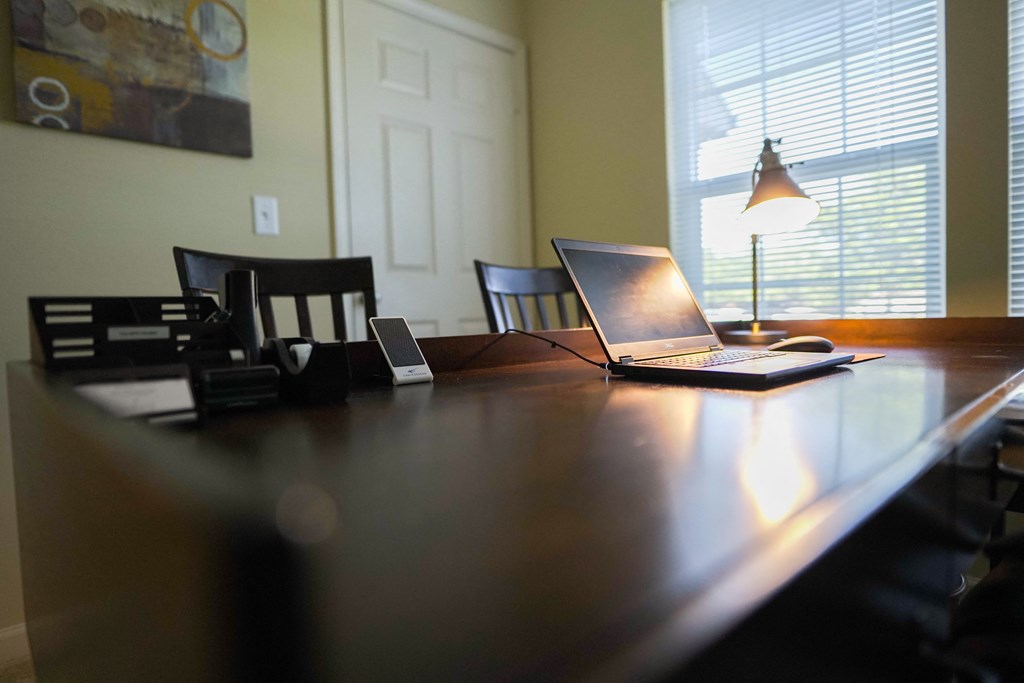 a laptop computer sitting on top of a wooden desk